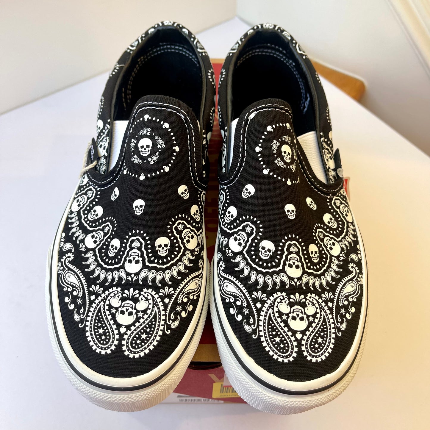 Vans Classic Slip On shoes in black / white bandana skull skate sneaker